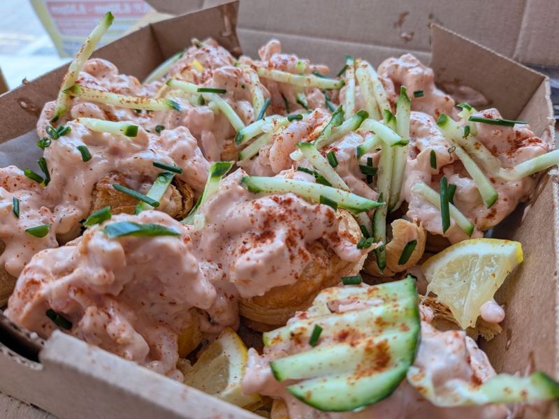 A box of vol-au-vents topped with prawns in Marie Rose sauce, cucumber and paprika