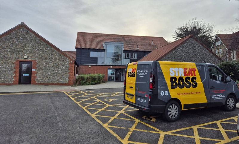 The yellow and grey Streat Boss van parked outside a flint community centre